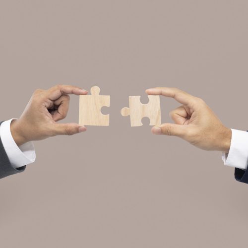 Hands holding puzzle business problem solving concept